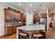 Spacious kitchen boasts granite countertops, stainless appliances, and a large island with seating at 7851 E 148Th Dr, Thornton, CO 80602