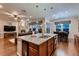Open kitchen with granite counters, modern appliances, and seamless flow into the living and dining areas at 7851 E 148Th Dr, Thornton, CO 80602