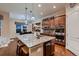 Well-appointed kitchen with an island, modern appliances, ample cabinet space, and adjacent dining area at 7851 E 148Th Dr, Thornton, CO 80602