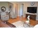 Bright living room area with hardwood floors, comfortable seating, and easy access to other rooms at 7851 E 148Th Dr, Thornton, CO 80602