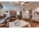 Living area with hardwood flooring, a fireplace, comfortable seating, and easy access to the kitchen at 7851 E 148Th Dr, Thornton, CO 80602