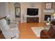 Inviting living room with hardwood floors, a fireplace, and comfortable seating arrangement at 7851 E 148Th Dr, Thornton, CO 80602