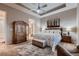 This main bedroom features tray ceilings, a ceiling fan, carpet and an ensuite bathroom at 7851 E 148Th Dr, Thornton, CO 80602