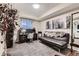 Home office featuring a work desk, chair, modern futon, large houseplant and scenic backyard view at 7851 E 148Th Dr, Thornton, CO 80602