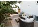 Backyard sitting area features a comfortable sofa and chair, nestled among lush greenery at 4212 Lowell Blvd, Denver, CO 80211