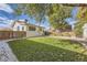 Backyard features include healthy lawn, rock details, garden, and privacy fence at 4212 Lowell Blvd, Denver, CO 80211