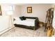 Cozy basement living space with stylish daybed, decor, and a colorful rug at 4212 Lowell Blvd, Denver, CO 80211