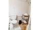 This is a picture of a toilet, garbage can, and shelving unit with towels in the bathroom at 4212 Lowell Blvd, Denver, CO 80211