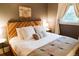 Cozy bedroom featuring a stylish headboard, throw pillows, and ample natural light at 4212 Lowell Blvd, Denver, CO 80211