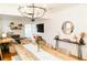 Open-concept dining area with modern chandelier, view to living room, and stylish decor at 4212 Lowell Blvd, Denver, CO 80211