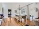 Bright dining room with a rustic wooden table, bench, and modern chandelier fixture at 4212 Lowell Blvd, Denver, CO 80211