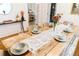 Charming dining room with rustic table, set with plates and glasses, offering a cozy atmosphere at 4212 Lowell Blvd, Denver, CO 80211