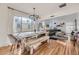 Open dining area features a long wood table, modern lighting, and view into living space at 4212 Lowell Blvd, Denver, CO 80211