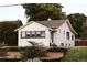 Charming white brick home featuring well-manicured landscaping and a cozy, inviting facade at 4212 Lowell Blvd, Denver, CO 80211