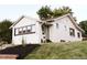 Charming exterior of a well-maintained home with new landscaping, and a green front door at 4212 Lowell Blvd, Denver, CO 80211