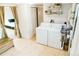 Bright laundry area features modern appliances and storage, enhancing functionality and convenience at 4212 Lowell Blvd, Denver, CO 80211