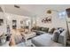 Open living room with wood floors, gray sectional, dining area, and abundant natural light at 4212 Lowell Blvd, Denver, CO 80211