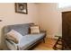 A cozy living room area with a grey couch with pillows and a cabinet at 4212 Lowell Blvd, Denver, CO 80211