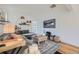 Cozy living room showcases a gray sectional, wood floors, and a modern entertainment setup at 4212 Lowell Blvd, Denver, CO 80211