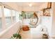 Cozy sunroom with natural light, hanging chair, and unique decor at 4212 Lowell Blvd, Denver, CO 80211