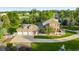Aerial view of estate featuring a large home, lush landscaping, and a multi-car garage at 5700 S Steele St, Greenwood Village, CO 80121