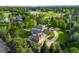 Sprawling property featuring a well-maintained lawn, three-car garage, and circular driveway at 5700 S Steele St, Greenwood Village, CO 80121
