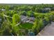 Stunning aerial view of a vast property with a sprawling lawn, mature trees, and white fencing at 5700 S Steele St, Greenwood Village, CO 80121