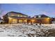 The backyard has manicured gardens, a covered patio, and a brick extension of the main building at 5700 S Steele St, Greenwood Village, CO 80121