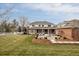 Expansive backyard with well-manicured lawn, mature trees, and a patio at 5700 S Steele St, Greenwood Village, CO 80121