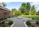 Landscaped backyard featuring decorative gravel, manicured shrubs, and mature trees providing shade at 5700 S Steele St, Greenwood Village, CO 80121