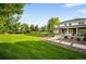 Lush backyard with stone patio and manicured lawn at 5700 S Steele St, Greenwood Village, CO 80121