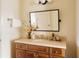 Charming bathroom featuring a wooden vanity, decorative mirror, and stylish lighting fixtures at 5700 S Steele St, Greenwood Village, CO 80121