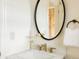 Elegant bathroom with a marble vanity, modern fixtures, and decorative mirror at 5700 S Steele St, Greenwood Village, CO 80121