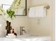 Bright bathroom featuring a marble countertop, modern faucet, and decorative touches like flowers and stylish accessories at 5700 S Steele St, Greenwood Village, CO 80121