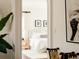 View through doorway of a serene bedroom with neutral decor, including a luxurious bed at 5700 S Steele St, Greenwood Village, CO 80121