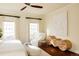 A brightly lit bedroom showcasing hardwood floors, bench and chair and decorative art at 5700 S Steele St, Greenwood Village, CO 80121