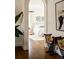 Arched doorway into a serene bedroom with hardwood floors, white bedding, and stylish decorative accents at 5700 S Steele St, Greenwood Village, CO 80121