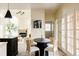 Bright dining area with modern round table, adjacent to living room, filled with natural light at 5700 S Steele St, Greenwood Village, CO 80121