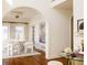 An elegant dining room featuring an arched doorway, round table, and bright natural light at 5700 S Steele St, Greenwood Village, CO 80121