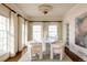An elegant dining room featuring a round table and bright natural light from large windows at 5700 S Steele St, Greenwood Village, CO 80121
