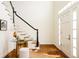 Inviting entryway with hardwood floors, stylish decor, a bright front door, and an elegant staircase with black and white accents at 5700 S Steele St, Greenwood Village, CO 80121