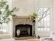 Stone fireplace with decorative mantel in a bright living room filled with natural light at 5700 S Steele St, Greenwood Village, CO 80121