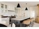 Kitchen featuring a large center island with bar seating, white cabinetry, and stylish pendant lighting at 5700 S Steele St, Greenwood Village, CO 80121