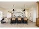 Bright kitchen featuring a large island with bar stool seating and modern pendant lighting at 5700 S Steele St, Greenwood Village, CO 80121