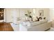 Bright and airy living room featuring white sofas, hardwood floors and an arched doorway at 5700 S Steele St, Greenwood Village, CO 80121