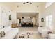Open living space with views of the kitchen, featuring neutral decor, and large windows at 5700 S Steele St, Greenwood Village, CO 80121