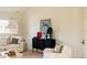 Stylish living room boasts a black accent cabinet, white upholstered furniture, and tasteful decor at 5700 S Steele St, Greenwood Village, CO 80121