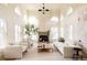 Bright living room featuring high ceilings, arched windows, a stone fireplace, and stylish neutral decor at 5700 S Steele St, Greenwood Village, CO 80121