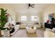 Spacious living room features a comfortable white sectional, ceiling fan, and a large window, creating a relaxing atmosphere at 5700 S Steele St, Greenwood Village, CO 80121