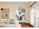 Open concept living room and dining room featuring hardwood floors, arched doorways and bright natural light at 5700 S Steele St, Greenwood Village, CO 80121